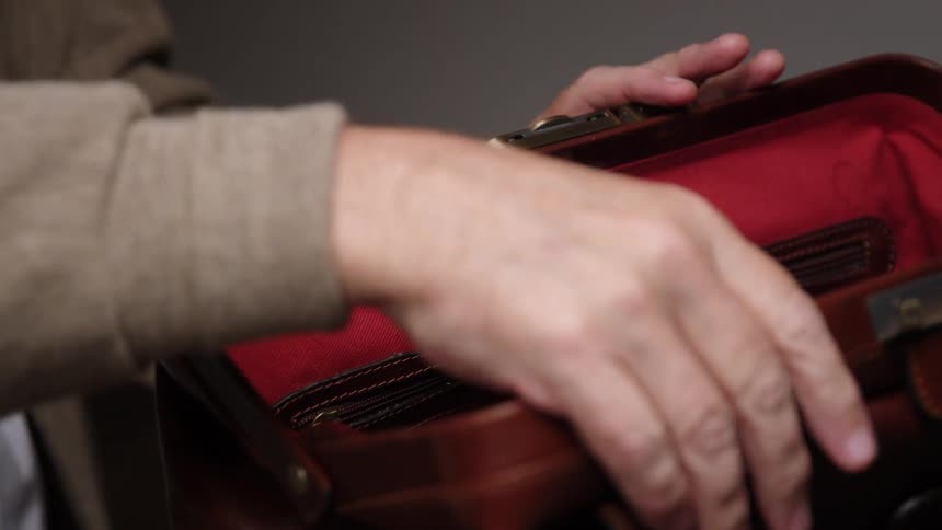 Doctor stores stethoscope in a travel bag