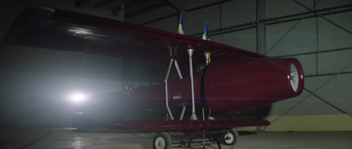 Red airplane in a dimly lit hangar
