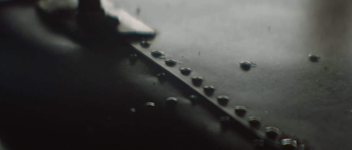 Rivets on the seams of metal sheets in a dimly lit room