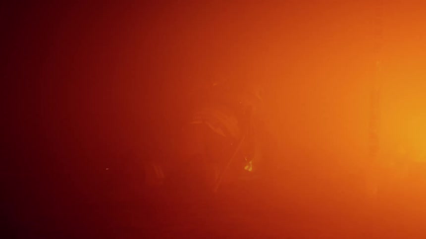 A firefighter crawling through a burning building