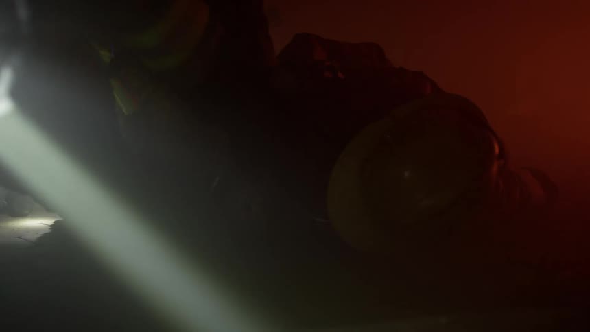 Firefighter rescues a colleague from a building in a training exercise