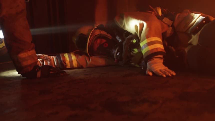 A firefighter is collpases in a building