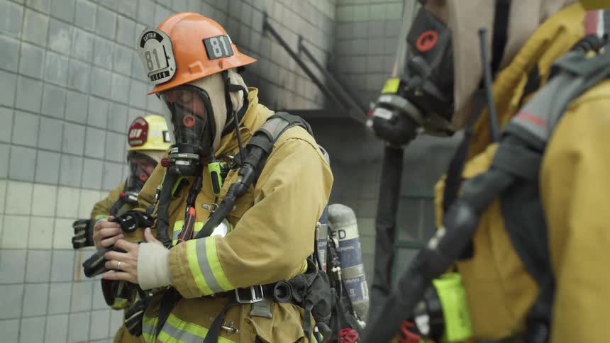 Firefighters check equipment before entering building on a training exercise