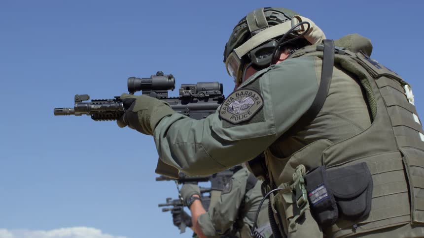 Two military police shoot rifles