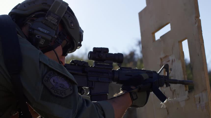 A military police shoots his gun