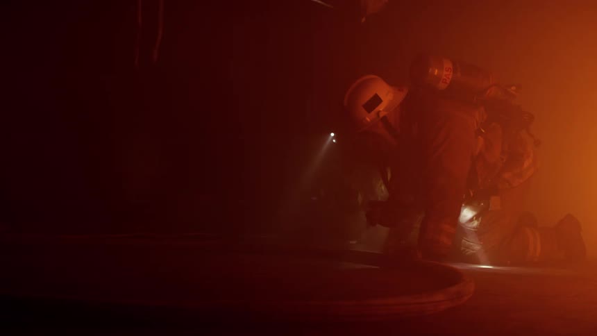 Firefighters search through the smoke