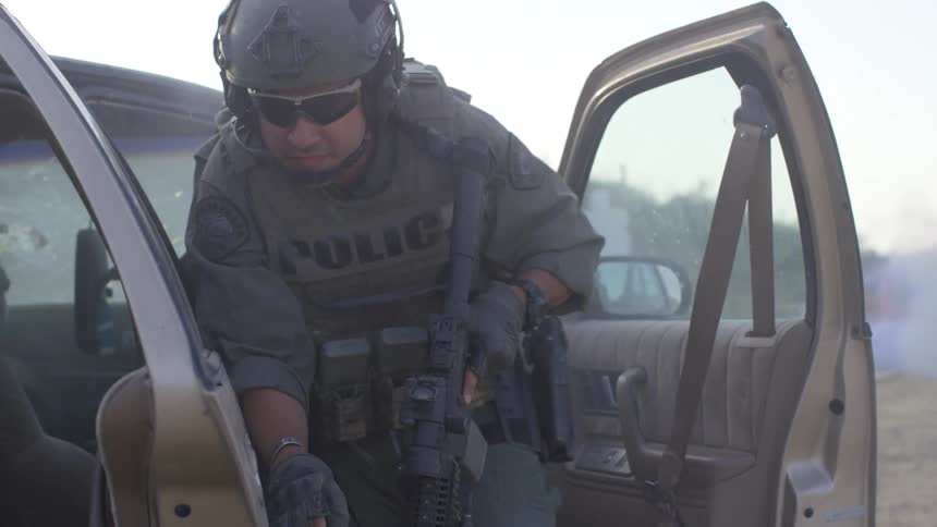 Soldier jumps out of car and takes shelter behind bumper