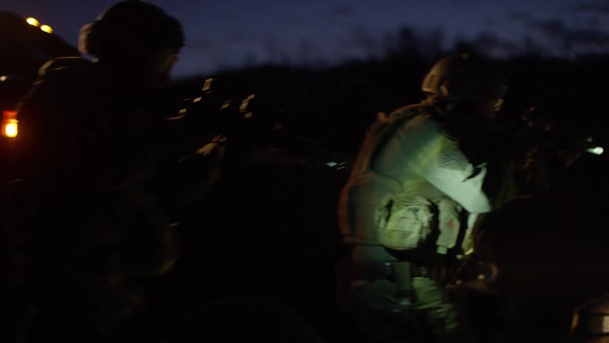 Police officers in military gear on a training exercise at night