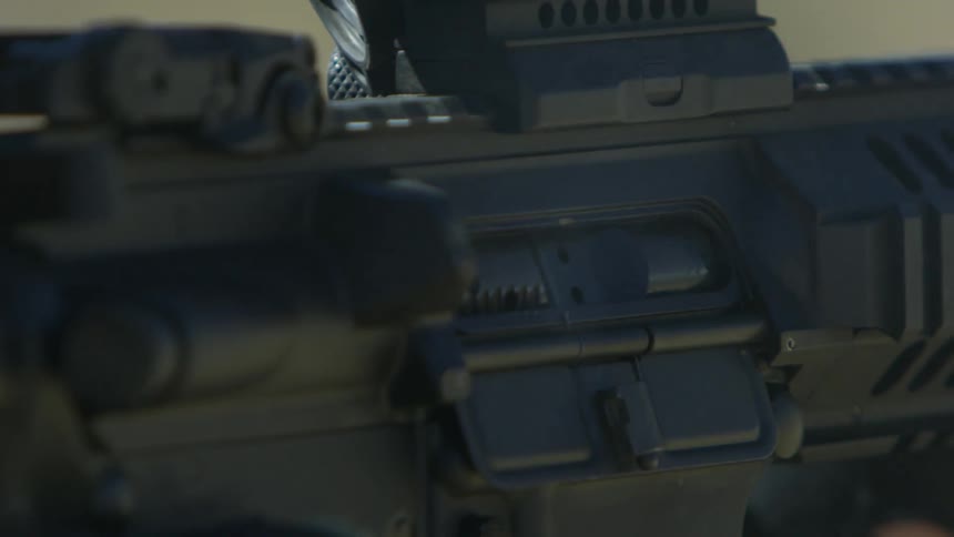 Close up of an assault rifle firing a bullet