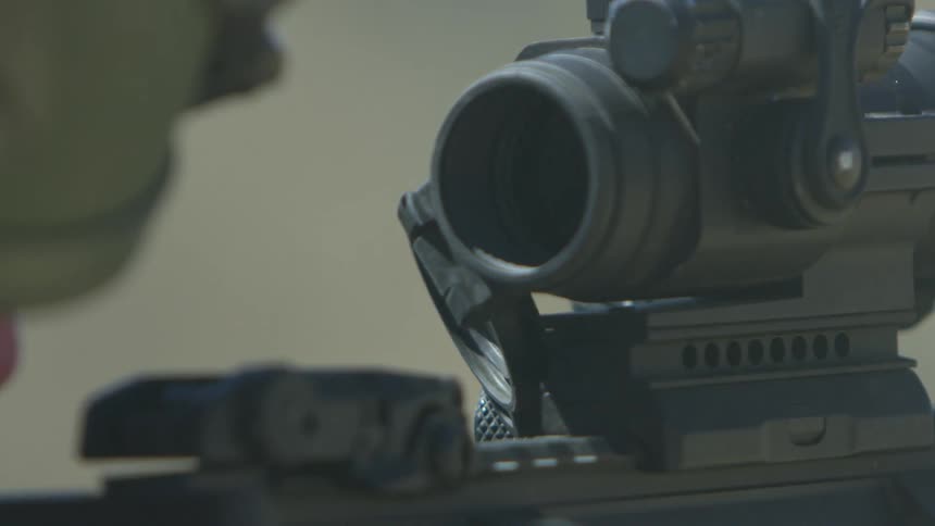 A soldier fires a gun