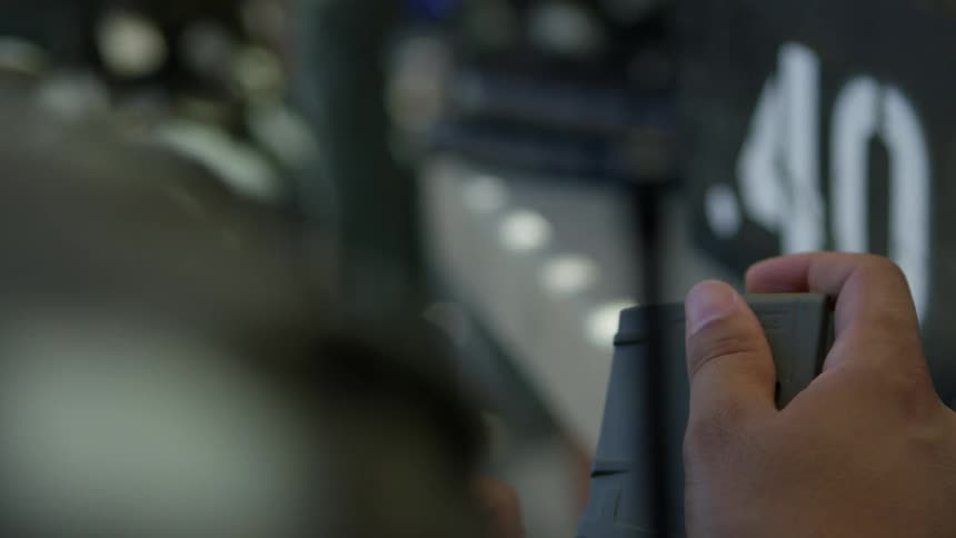 A soldier loads bullets in his gun