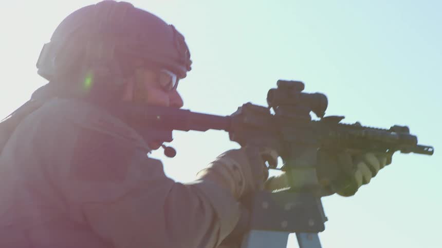 A military police shoots a gun