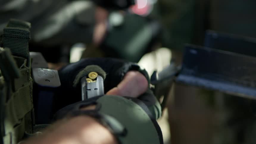 Soldiers loading bullets in to their guns