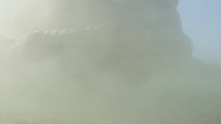 A soldier is firing laying on the ground