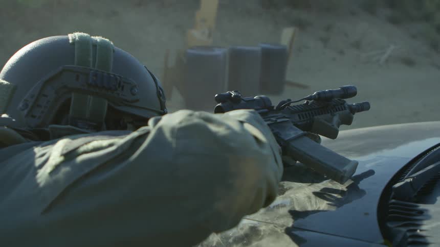 A military police shoots his gun