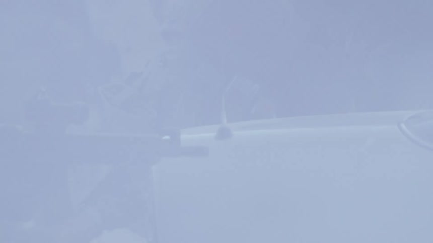 Army soldiers surrounded by smoke shoot assault rifle near car