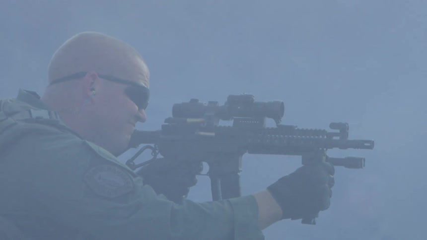 A military police shoots his gun outside