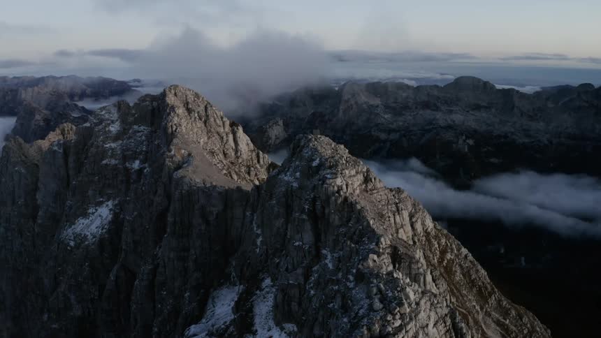 A mountain range with clouds and the sky in the background