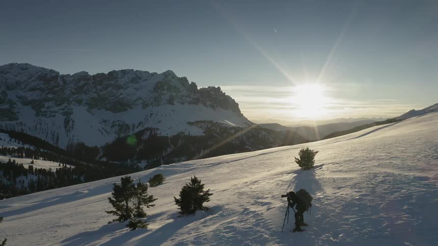A photographer takes pictures on a snowy mountain