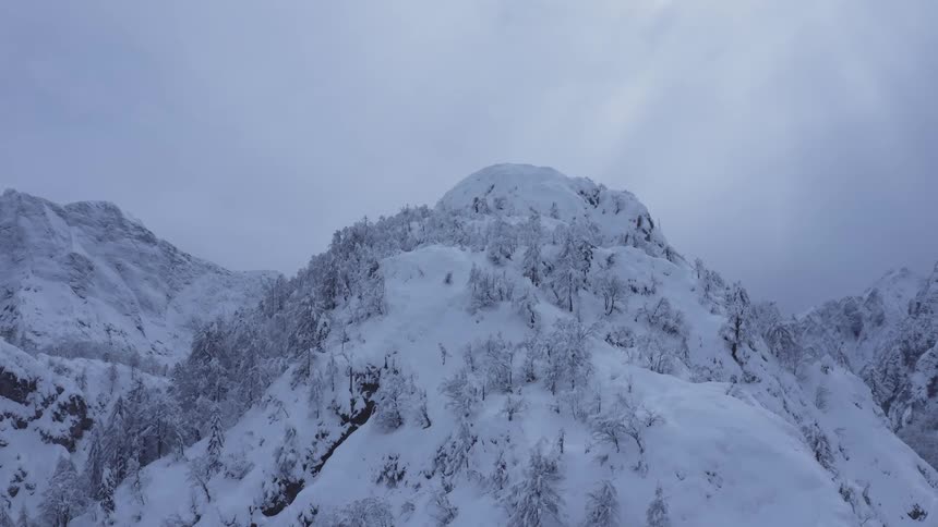 Aerial of snow covered mountain peaks