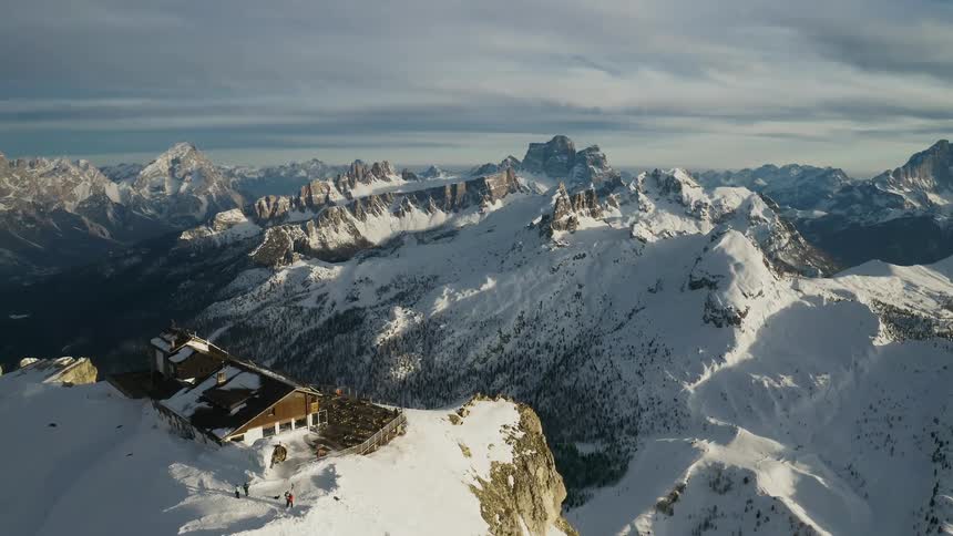 Aerial of a house on a summit overlooking a mountain range