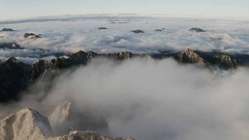 A mountain range with clouds and the sky in the background