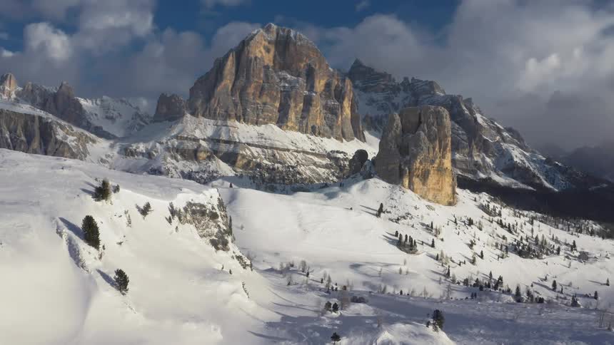 The mountains are covered with snow near the slopes