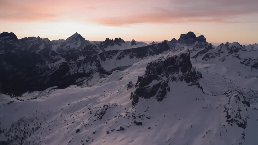 Aerial view of snow capped mountains at dusk