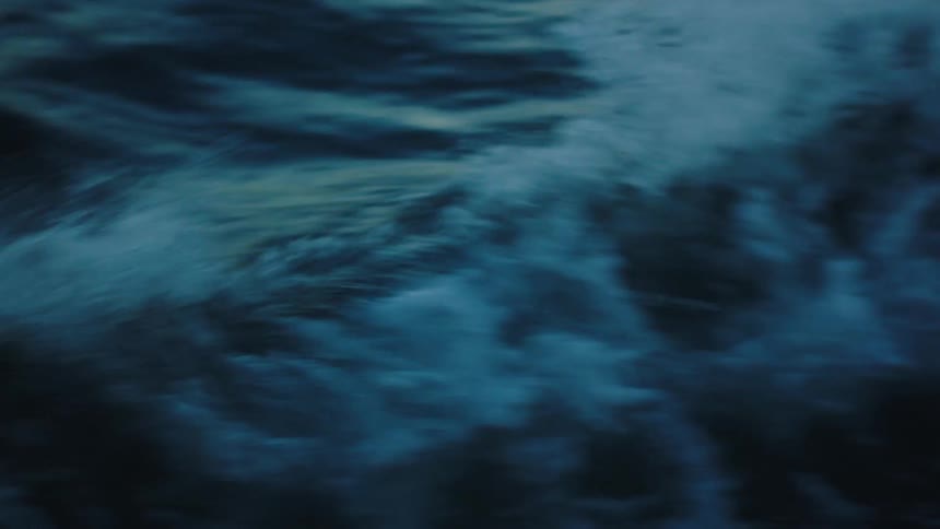 Strong waves crash in ocean blue waters