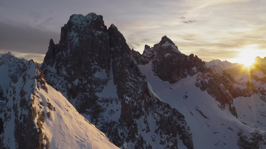 The sun peaking over a mountain top