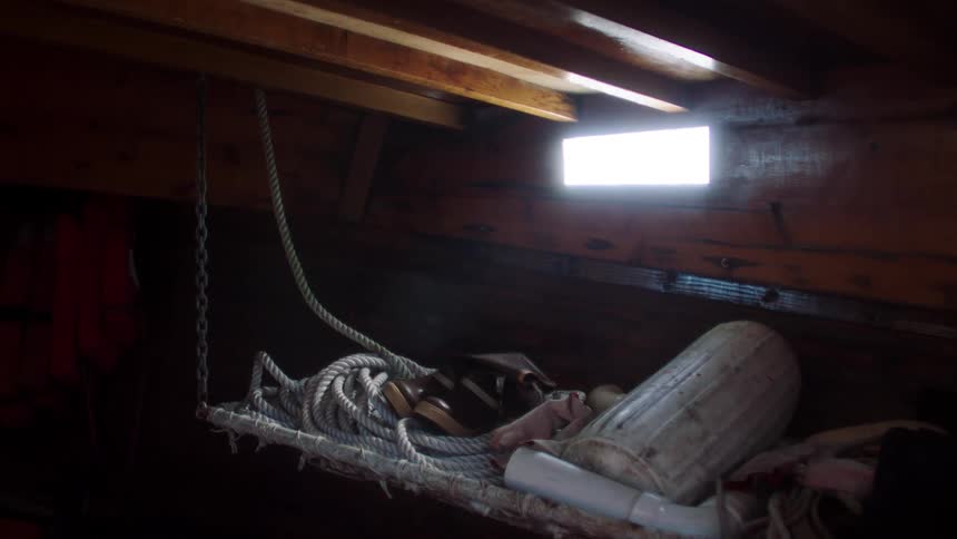 The rope is hanging in the boat cabin