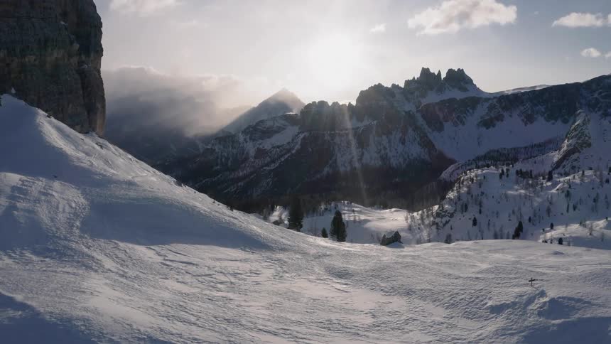 Aerial view of snow covered mountain range at sunset