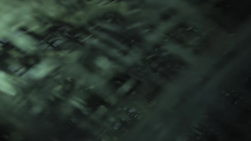 Green white gray and black colors that look like a cage traveling in a vehicle