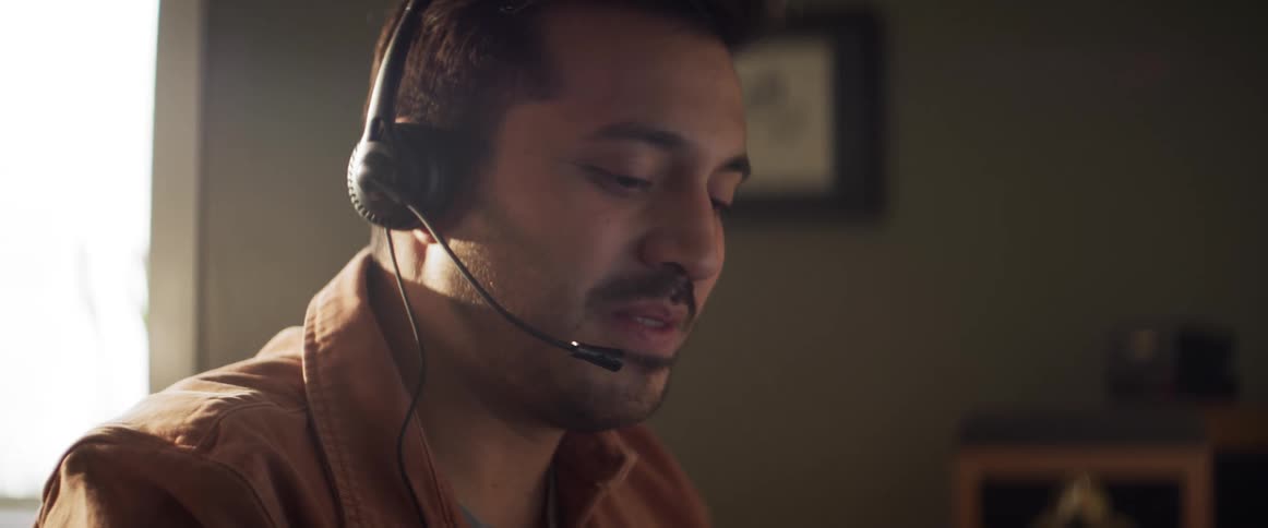 A man with a headset on talks