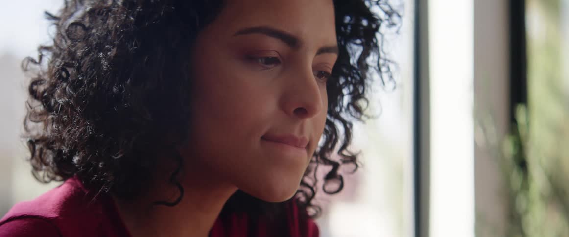 A woman looks at something examining it