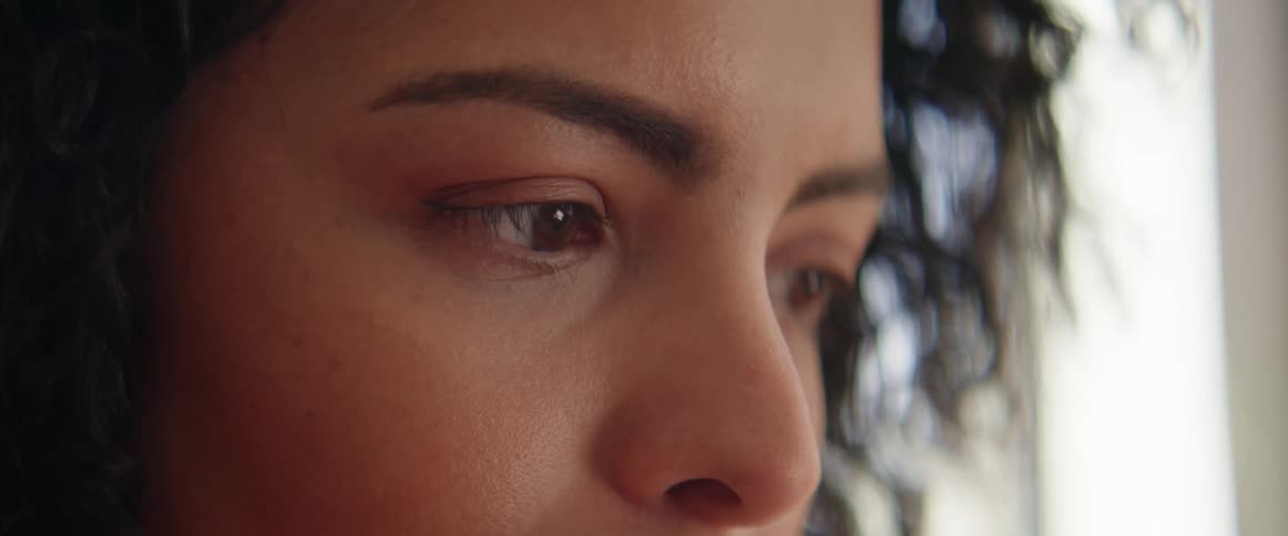 A woman is looking around at something