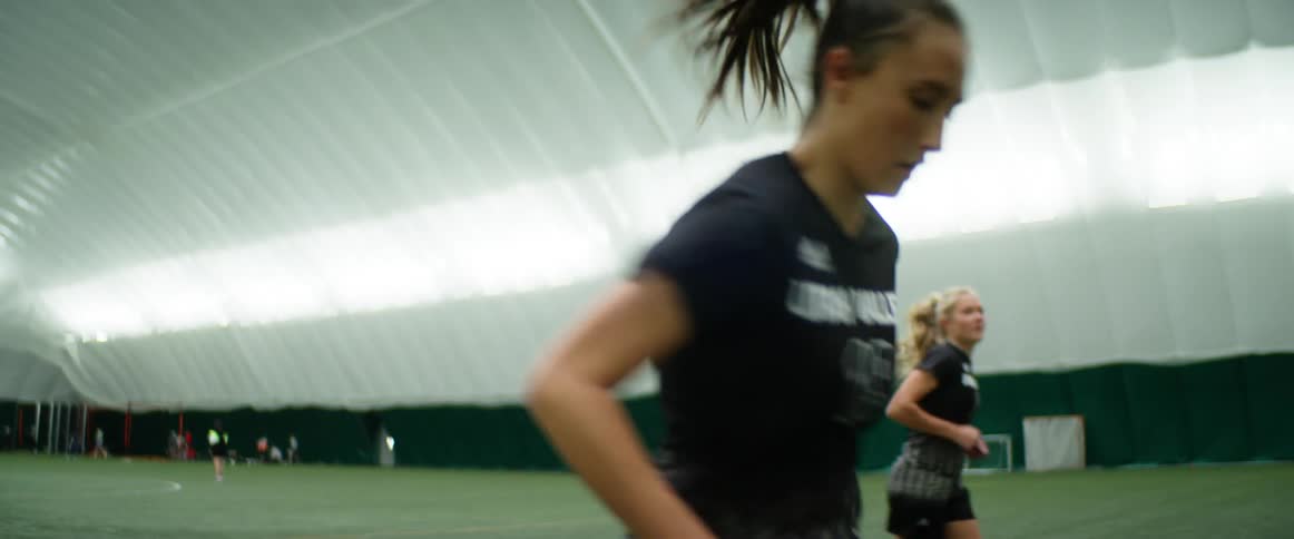 Female athletes practice in an indoor facility