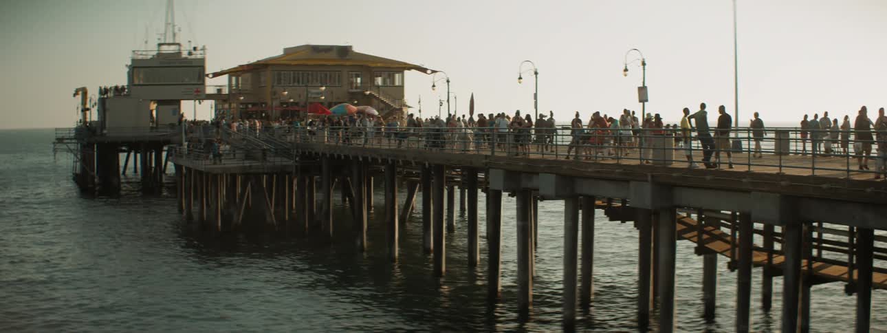 People gather together and walk on the pier