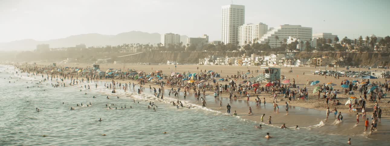 Large crowd of people enjoying a day at the beach