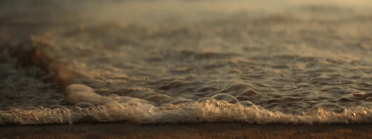 Waves washing over the sands of a beach