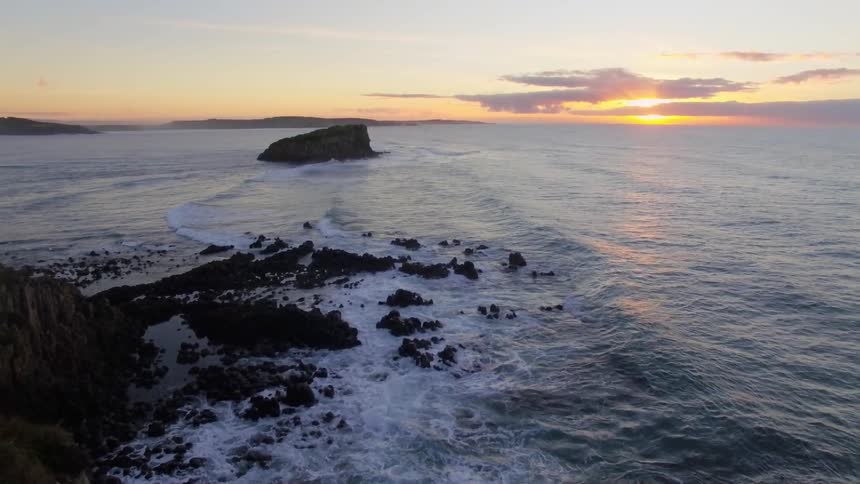 Watching the sunrise from a rocky cliff ledge