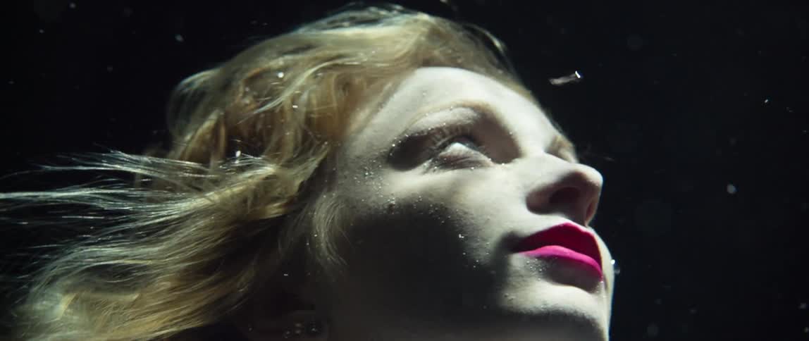 A fully clothed woman underwater