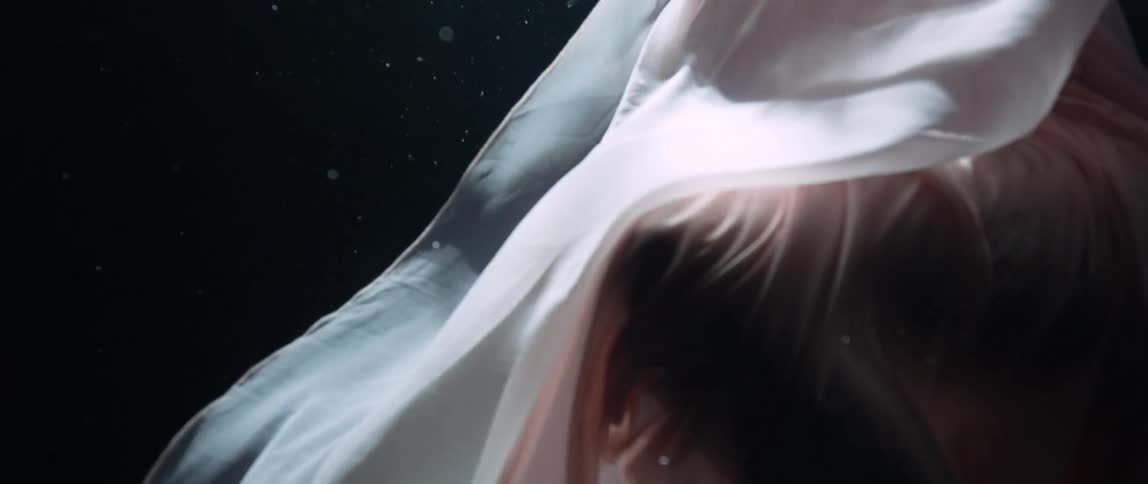 A fully clothed woman underwater