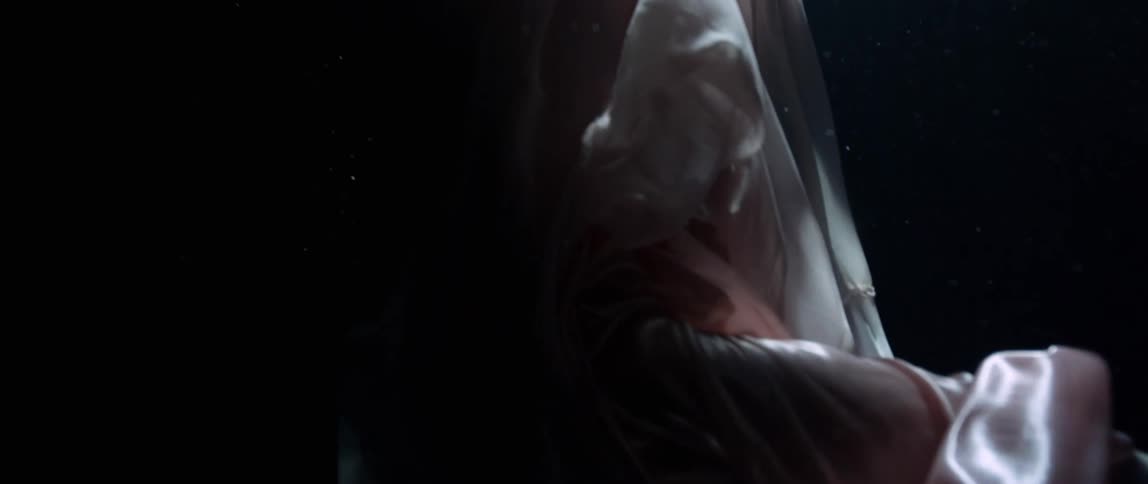 Model in flowing silk gown underwater