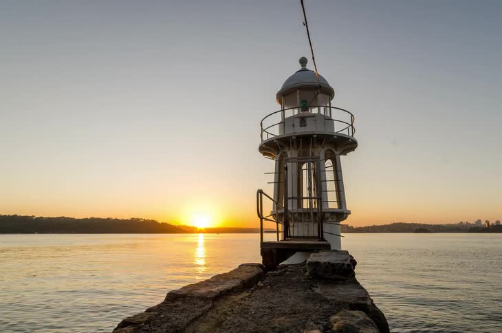 Timelapse of harbour lighthouse with rising sun
