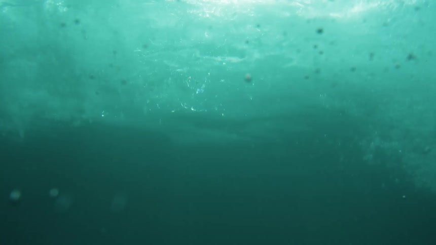 A large wave on the water and then a view under the water