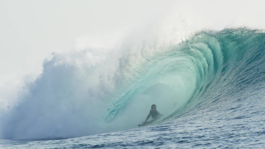 A person body boarding on a wave in the ocean