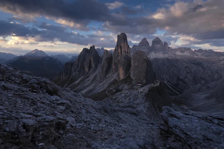 Clouds float over rocky rough terrain