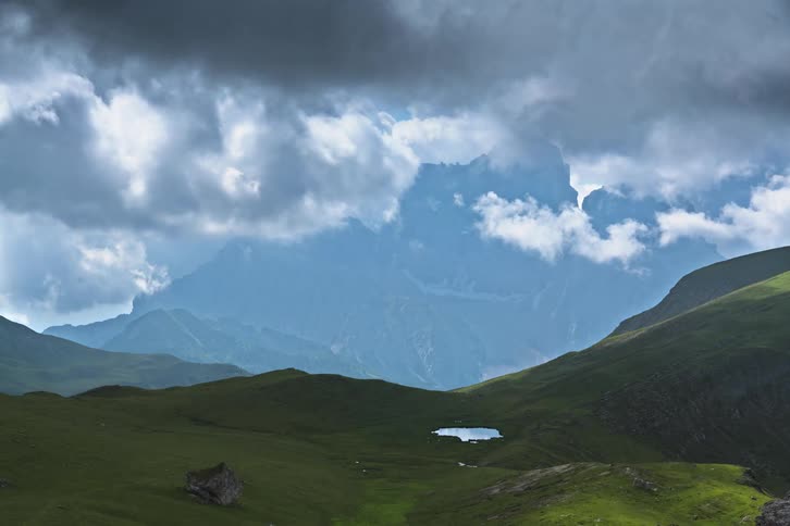 The mountain is covered with green grass