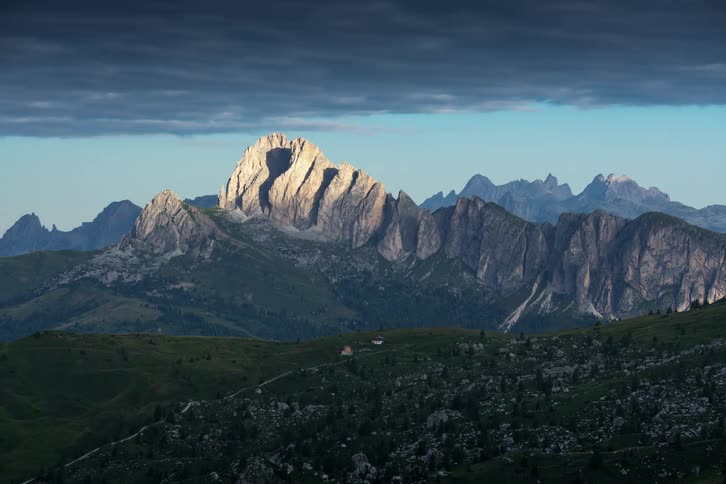Dark cloud bank passes over mountain range and valley